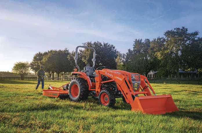 Man walking towards tractor in a field