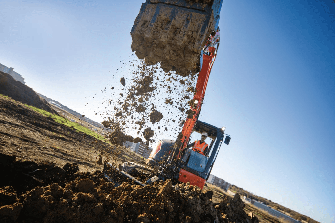 Close up of Kubota Excavator dumping dirt